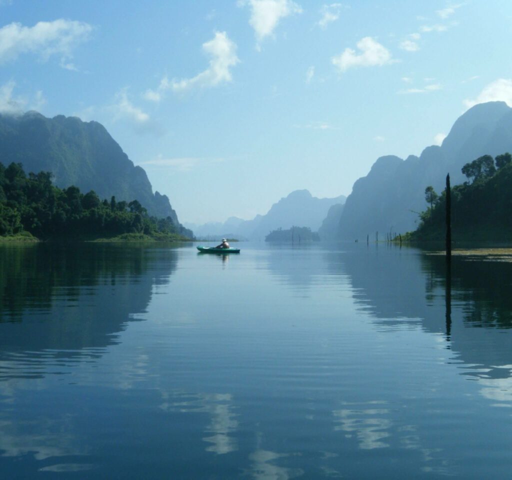 Man on Boat Under Blue Sky