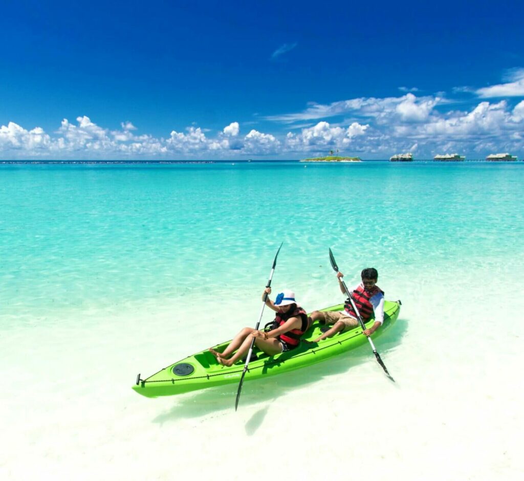 Two People Riding Green Kayak On Sea